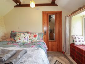 A bedroom with a bed and window seat at Moorland Retreat in Bodmin