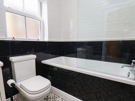 A bathroom with a bathtub and toilet at Sea View Apartment in Whitby