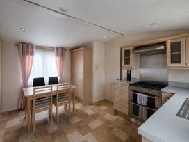A dining room with a table and chairs at Marine Holiday Park - 21NC in Rhyl