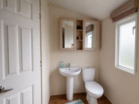 A bathroom with a sink and toilet at Marine Holiday Park - 21NC in Rhyl