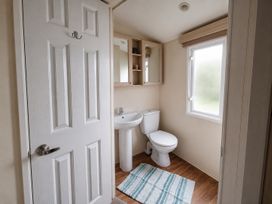 A bathroom with a sink and toilet at Marine Holiday Park - 21NC Rhyl