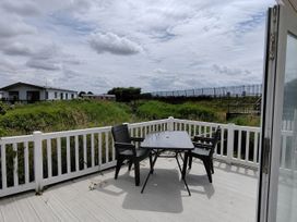 An outdoor area with a table and chairs at Marine Holiday Park - 21NC Rhyl