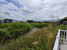 An outdoor area with holiday homes and a waterway at Marine Holiday Park - Rhyl