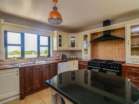 A kitchen with sink and stove at Vernegly in Banonow
