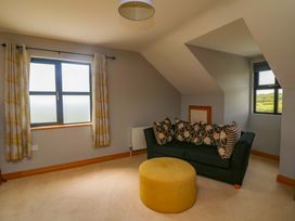 A sitting room with a sofa and ottoman at Vernegly in Banonow