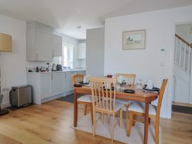 A dining room with a table and chairs at L'Ancresse Cottage in Lyme Regis