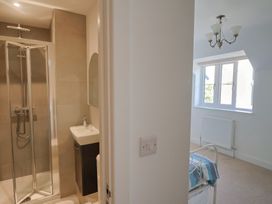 A bathroom with a shower and sink at L'Ancresse Cottage in Lyme Regis