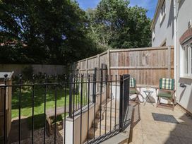 A garden with seating and a table at L'Ancresse Cottage in Lyme Regis
