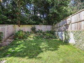 A garden with grass and plants at L'Ancresse Cottage in Lyme Regis