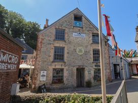 A building with signs and flags at the Town Mill in Lyme Regis