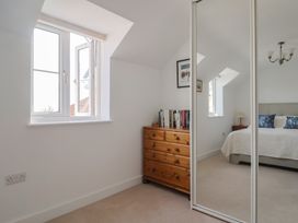 A bedroom with a bed and chest of drawers at L'Ancresse Cottage Lyme Regis
