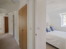 A bedroom with a bed and a window at L'Ancresse Cottage in Lyme Regis