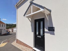 An entrance door with an awning at L'Ancresse Cottage in Lyme Regis