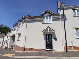 A house exterior with front door and lamp post at L'Ancresse Cottage Lyme Regis