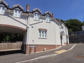 A residential building with windows and a driveway at L'Ancresse Cottage in Lyme Regis