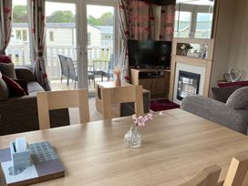 A living room with a table and sofa at Primrose Valley Park - Pebbles Retreat in Primrose Valley