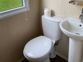 A bathroom with a toilet and sink at Primrose Valley Park - Pebbles Retreat in Primrose Valley