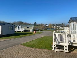 An outdoor area with holiday homes and a lake at Primrose Valley Park - Pebbles Retreat, Primrose Valley