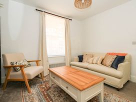 A living room with a sofa and an armchair at The Watch House in Weymouth
