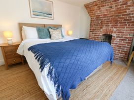 A bedroom with a bed and bedside tables at The Watch House in Weymouth