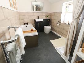 A bathroom with a bathtub, toilet, and sink at The Watch House in Weymouth