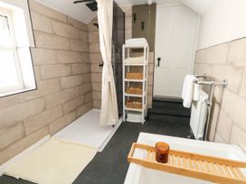 A bathroom with a shower and bathtub at The Watch House in Weymouth