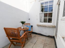An outdoor area with a table and chairs at The Watch House in Weymouth
