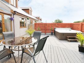 An outdoor area with a dining table and chairs at 1 The Old Smithy Cemaes Bay