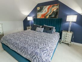 A bedroom with a bed and bedside tables at 1 The Old Smithy in Cemaes Bay