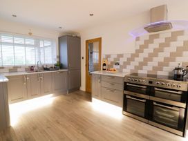 A kitchen with cabinets and a cooking range at Gwelfor, Cemaes Bay
