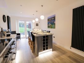 A kitchen with a table and chairs at Gwelfor in Cemaes Bay
