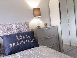 A bedroom with a pillow and lamp at Gwelfor in Cemaes Bay