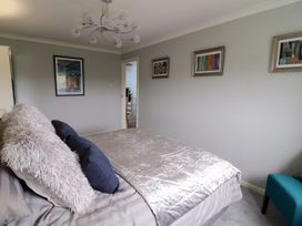 A bedroom with a bed and artwork at Gwelfor in Cemaes Bay