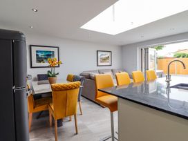 A kitchen with a table and chairs at Trefin in Cemaes Bay