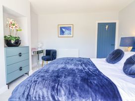 A bedroom with a bed and nightstand at Trefin Cemaes Bay