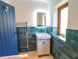 A bathroom with a sink and towel rail at Trefin in Cemaes Bay