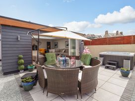 An outdoor area with a dining table and chairs at Trefin in Cemaes Bay