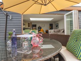 An outdoor seating area with a table and chairs at Trefin Cemaes Bay