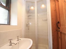 A bathroom with a shower and basin at Swallow Cottage in Helston