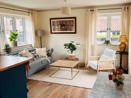 A living room with a sofa and coffee table at Badger Cottage in Wold Newton