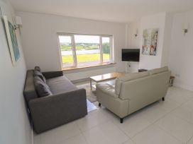 A living room with a sofa and coffee table at Tí Chonaill