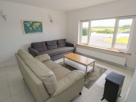 A living room with sofas and a table at Tí Chonaill