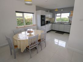 A kitchen with a dining table and chairs at Tí Chonaill in 