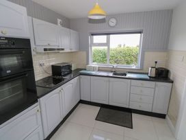 A kitchen with appliances and window at Tí Chonaill in 