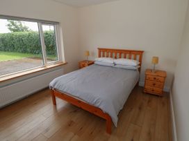 A bedroom with a bed and bedside tables at Tí Chonaill in 