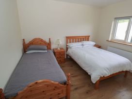 A bedroom with a single bed and a double bed at Tí Chonaill in 