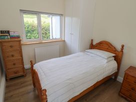 A bedroom with a bed and dresser at Tí Chonaill in 