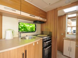 A kitchen with a sink and oven at Caravan in Dolton
