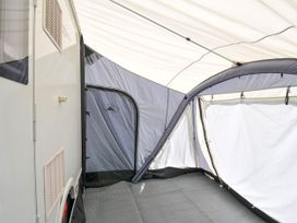 An interior view of a caravan with a tent structure at Caravan in Dolton