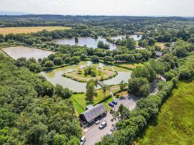An aerial view of a landscape with ponds and trees at Rod and Rest in Dolton